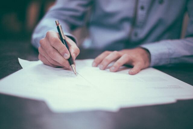 Man writing on paper. Illustration in correlation to Martyn's law