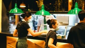 Two female waitresses waiting for food order